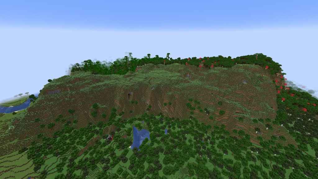 A steep Meadow Mountain in front of a Dark Forest.