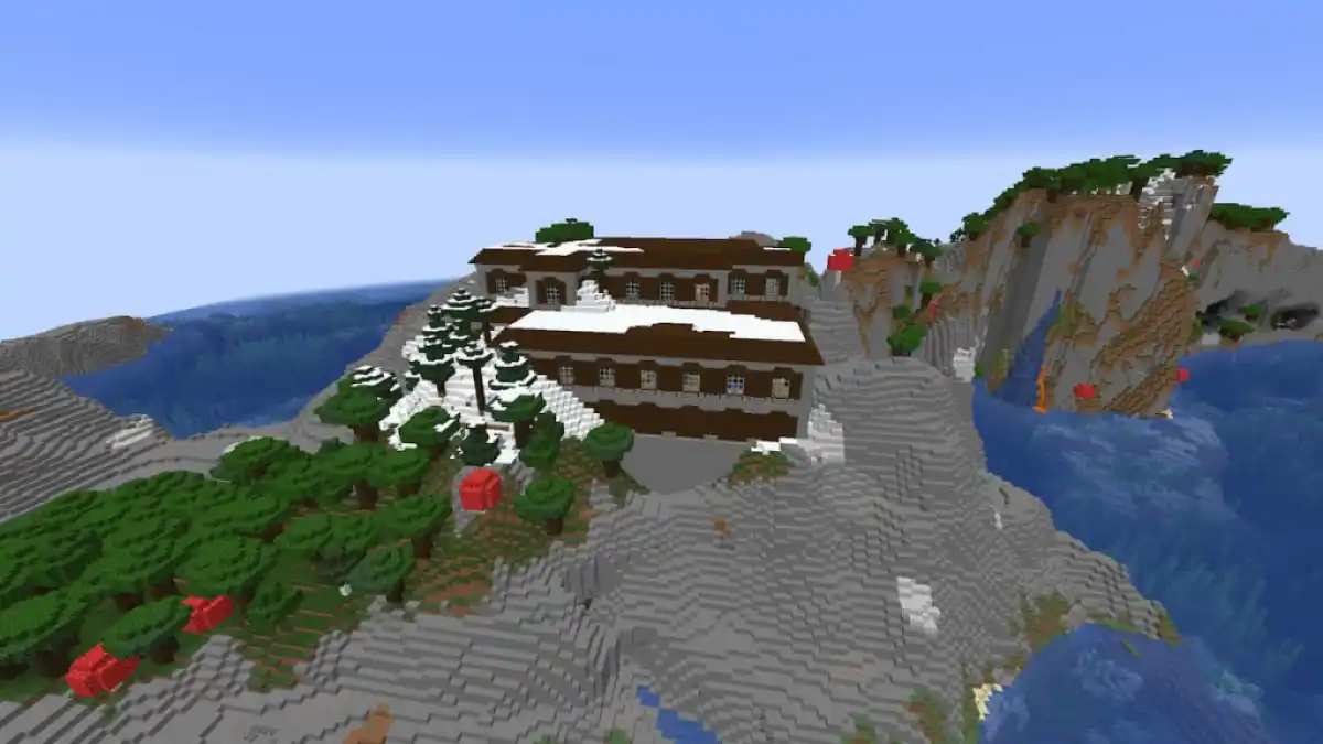 A snow-covered Woodland Mansion atop a stony biome surrounded by the ocean.