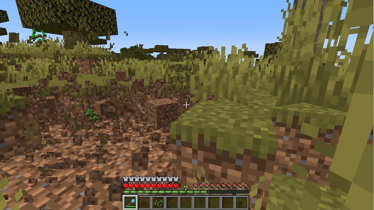 Using a shovel enchanted with Efficiency to dig up a lot of dirt in Minecraft.