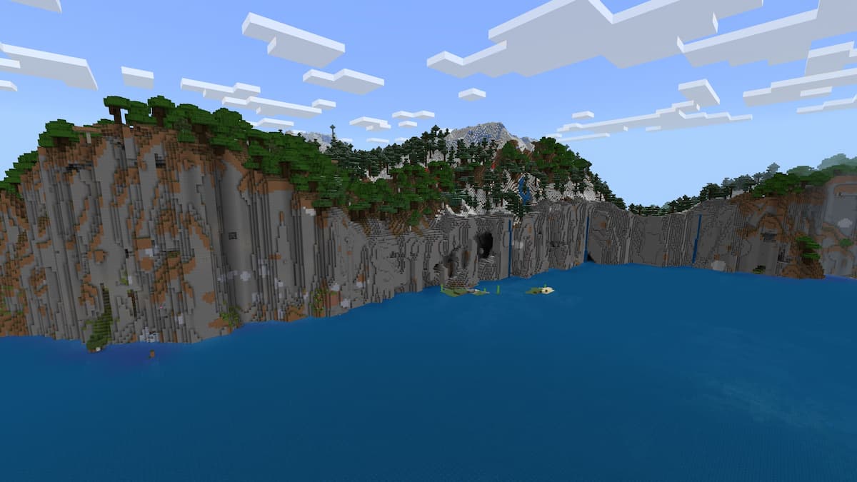 Sheer snowy cliffs next to the ocean in Minecraft.