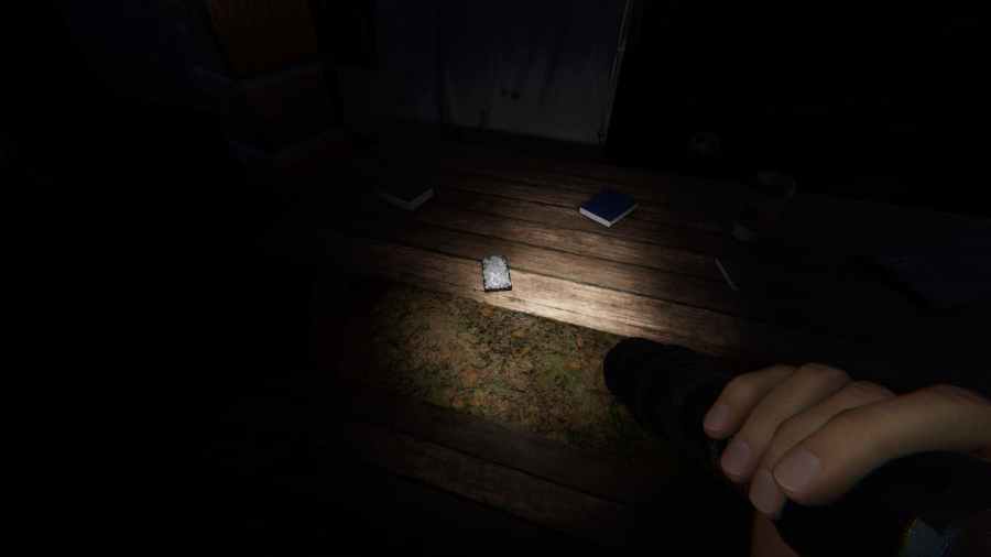 The location of the Tarot Card Cursed Item in Phasmophobia's Camop Woodwind.