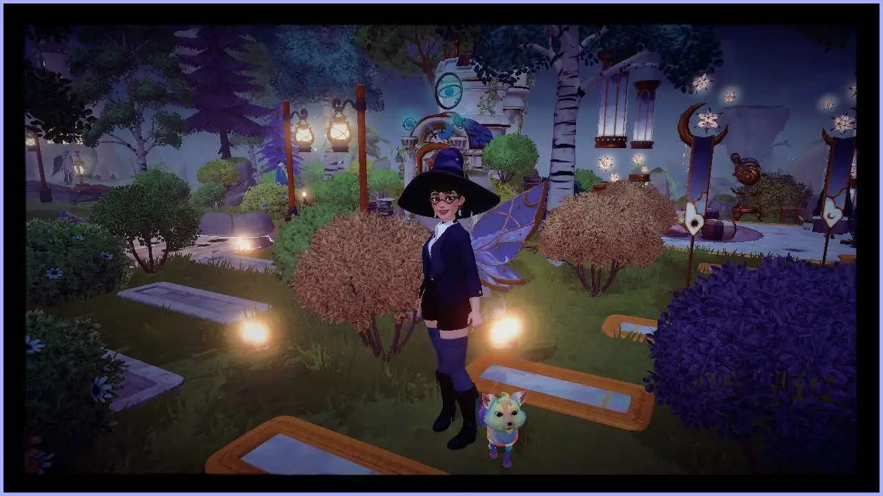 A female-presenting Disney Dreamlight Valley avatar dressed in a witch's hat with blue and gold wings stands among yellow bushes with a snarling rainbow fox.  In the background, Merlin's house is covered with trees.  There are candles scattered around near a gold-lined path.