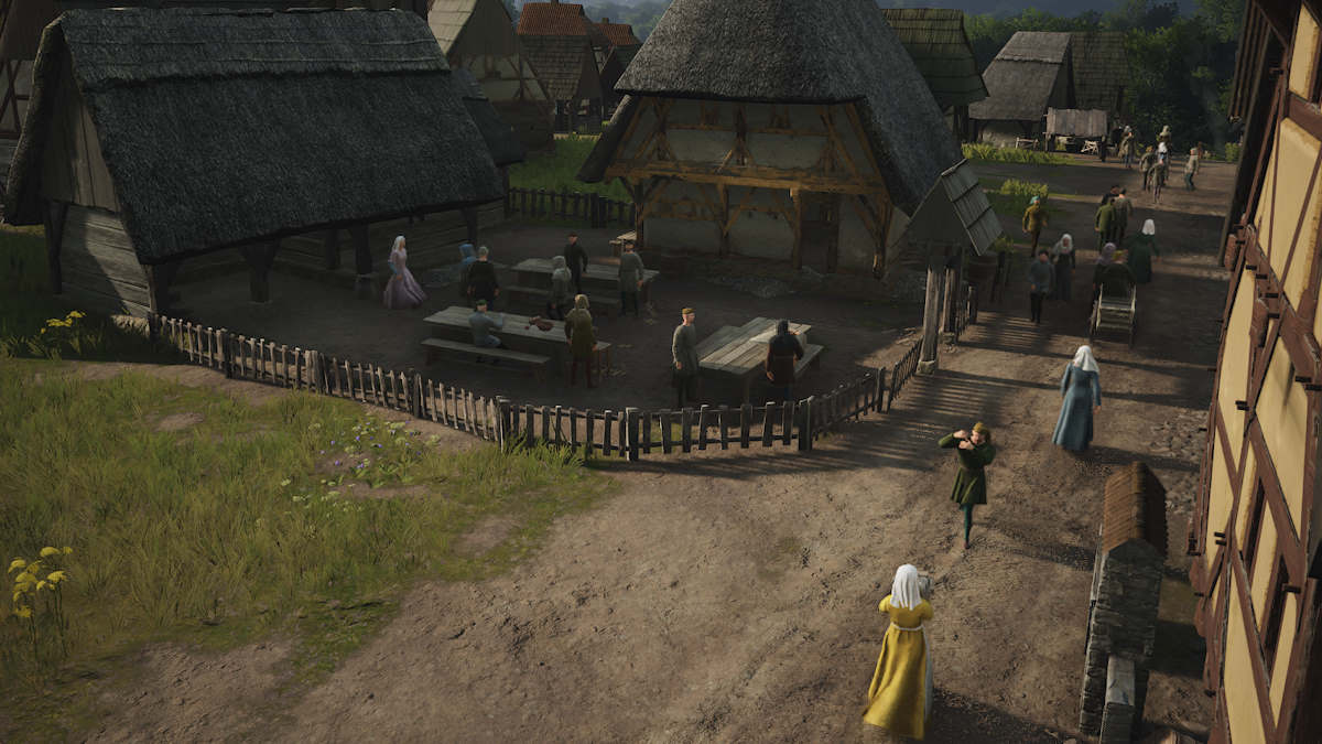 Villagers walking around the town in Manor Lords