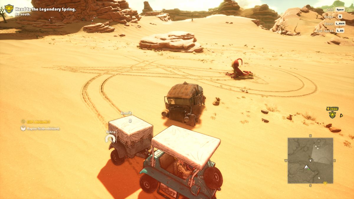 Rao's vehicle near a dead red raptor lying face-down in the sand with its rear in the air.