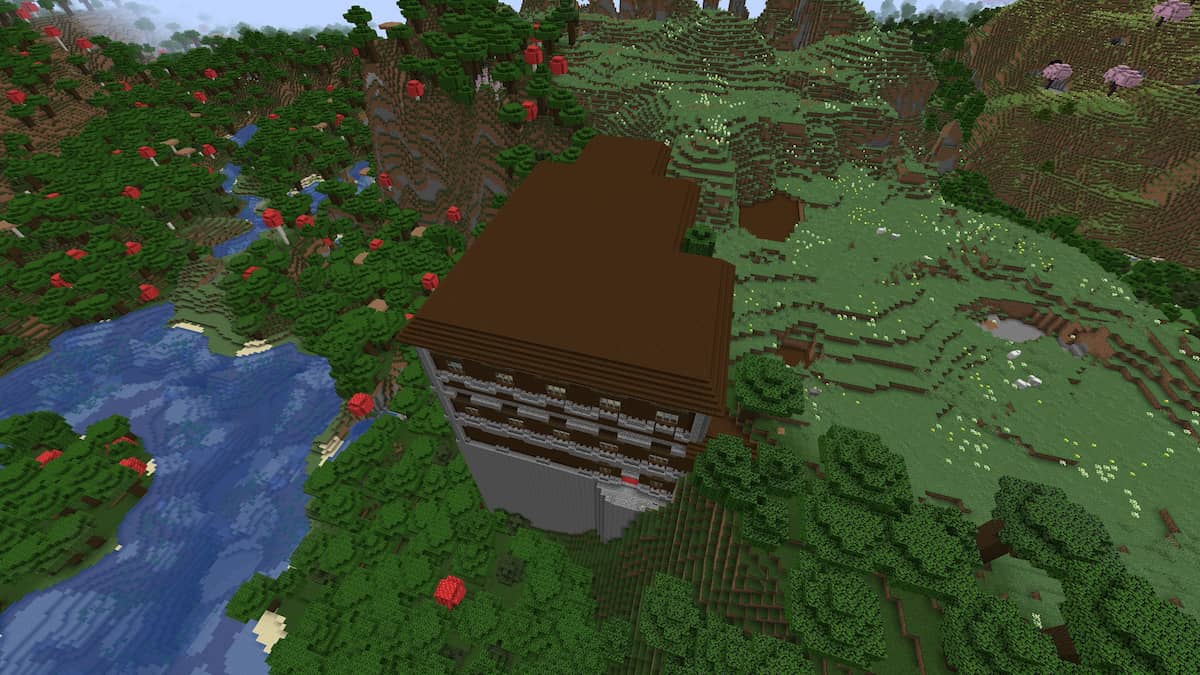 A Minecraft Woodland Mansion that is half buried in a mountain and half towering up the side of the mountain