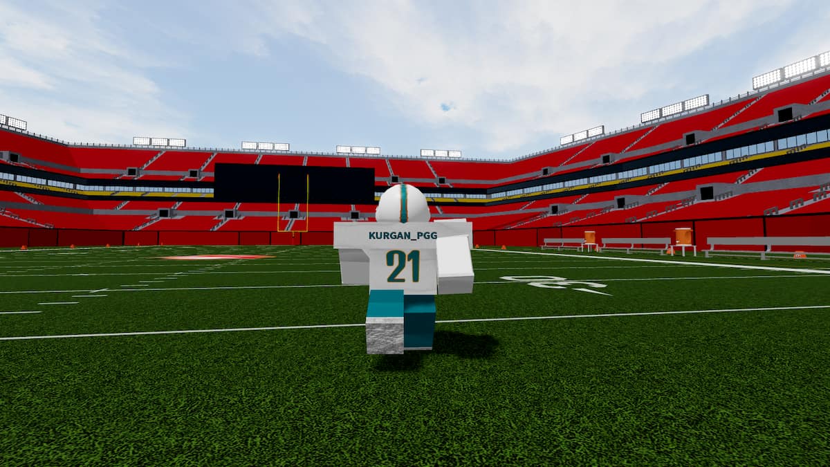 Football Fusion 2 player in Miami Dolphins uniform running across the football field
