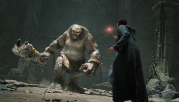 A wizard taking on a troll in Hogwarts Legacy