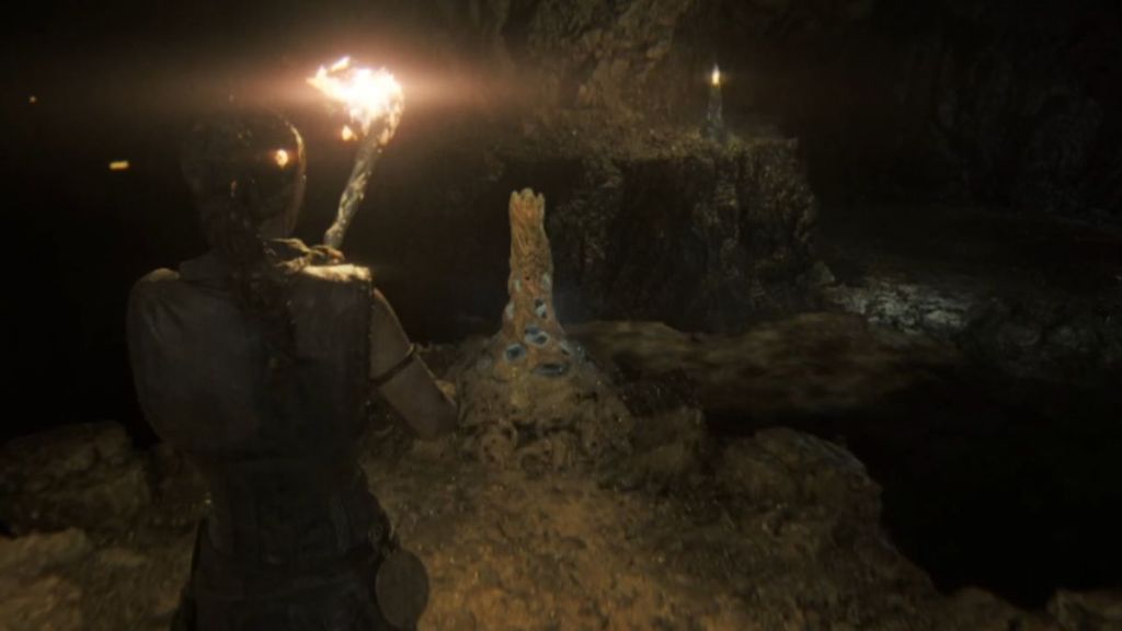 Unlit torch in the caves of Hellblade II