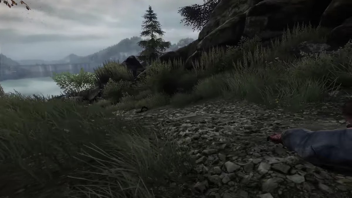 A bloodied hand reaches out on a path in The Vanishing of Ethan Carter. 