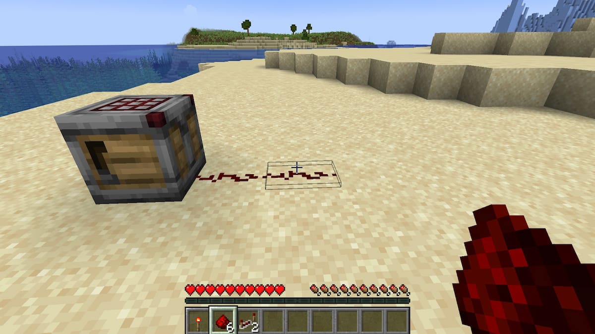 Placing two Redstone Dust behind a Crafter block in Minecraft