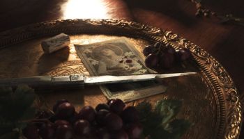 knife, grapes, and old image on the table in Mafia the Old Country