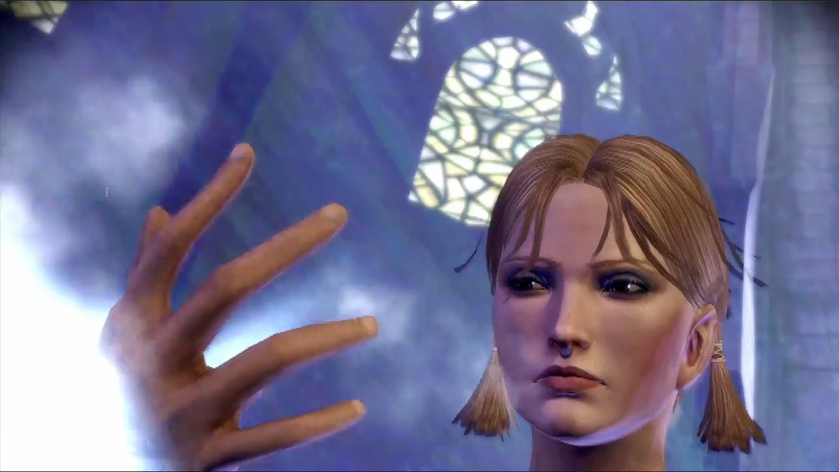 A blonde mage looks at the magic forming in her hand in Dragon Age: Origins.