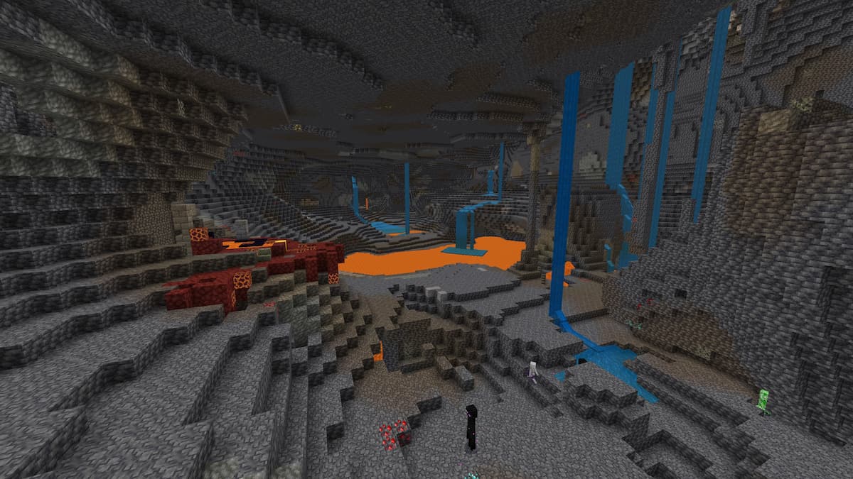 A Minecraft cave with lava lakes, waterfalls, and a ruined Nether portal