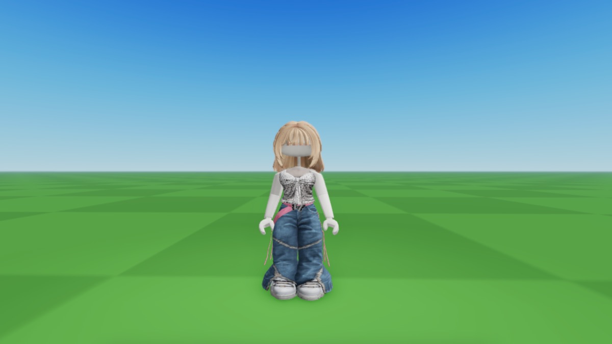 A Roblox avatar with blonde hair wearing white leopard print top with blue baggy jeans and a pink belt.