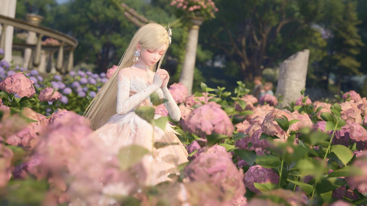 Nikki is praying in a filed of flowers while wearing a beautiful dress