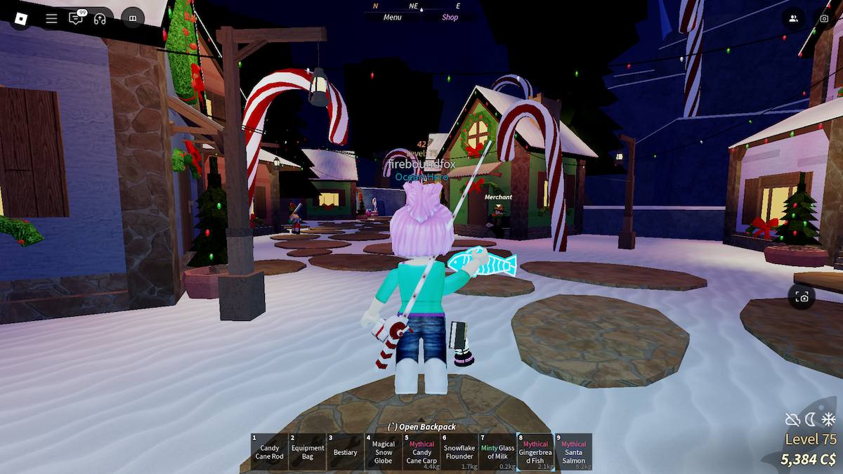 Player holding a Gingerbread Fish in the Winter Village in Fish.