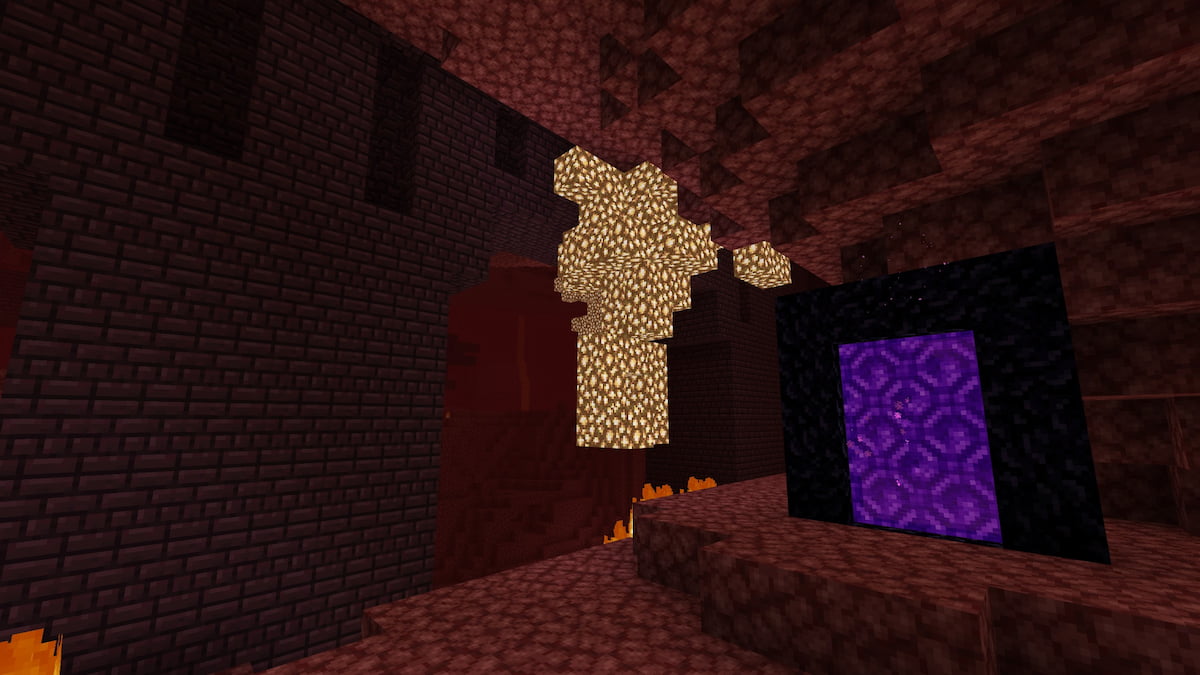 A Minecraft Nether portal next to a Nether Fortress