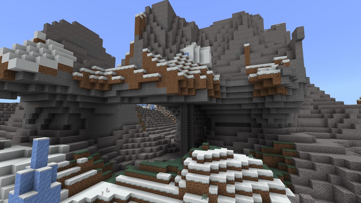 A Minecraft igloo with an exposed basement on the side of a hill