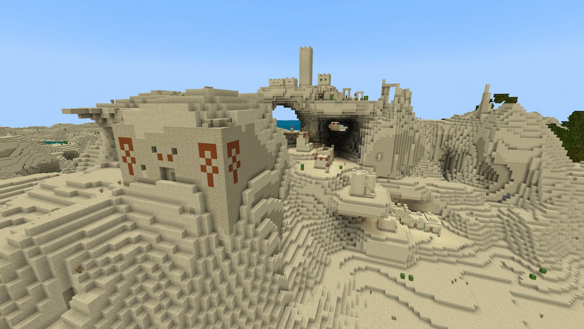 A Minecraft Desert Temple inside of a hill in front of a Desert Village